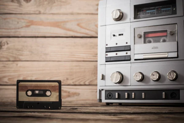 old tape recorder and cassette on  wooden background