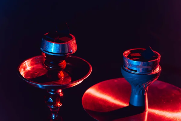 Hookah bowl, shisha and coals close-up on a black background with colored lighting — Stock Photo, Image