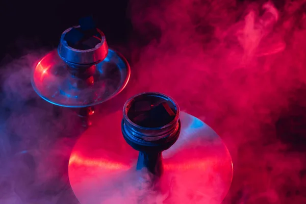Hookah bowl and coals close up on a black background with smoke — Stock Photo, Image