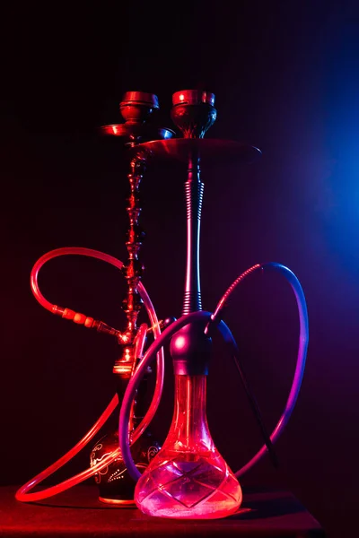 Modern hookah, shisha on a black background with neon lighting — Stock Photo, Image