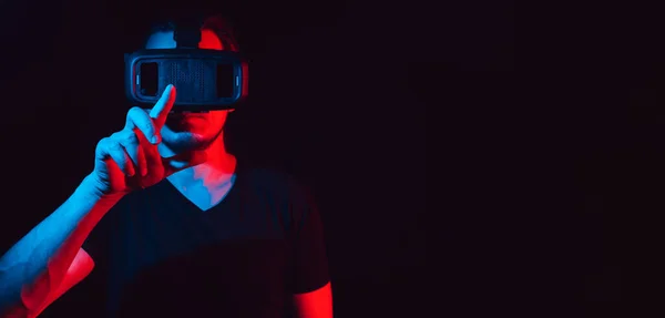 A young man using high-tech virtual reality glasses. with space for text