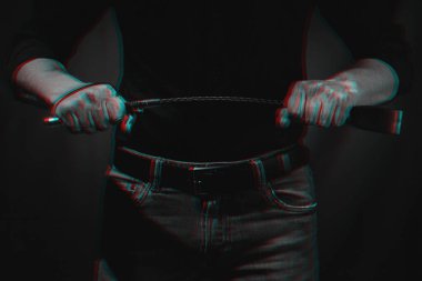Elinde BDSM kırbacı olan yakışıklı bir adam. 3 boyutlu sanal gerçeklik efektiyle siyah ve beyaz