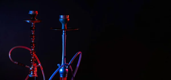 Modern hookah, shisha on a black background with colored lighting and smoke. Place for your text — Stock Photo, Image