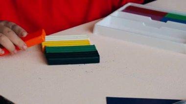 Video, renkli plastikten heykel yapan küçük bir çocuğun elleri. Yakın plan..