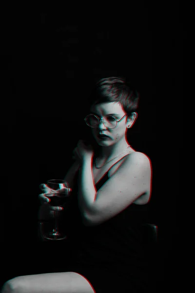 Beautiful young girl tries and evaluates red wine. Black and white with glitch effect — Stock Photo, Image