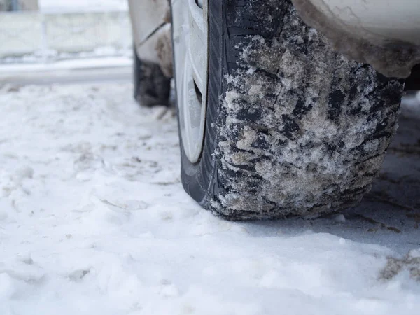 car on winter tires on a snow-covered road. tread on the tire.