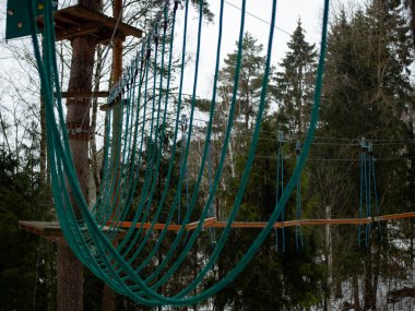 Halat kasabası. Sigortası olan ağaçlar arasında gerilmiş ipler.