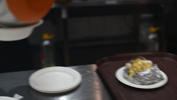 Homem fazendo refeição fast food no restaurante fast food vestindo luvas médicas azuis tema de comida de rua — Vídeo de Stock