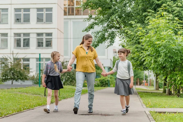 Two little happy girl with mom go to school education concept — Stock Photo, Image