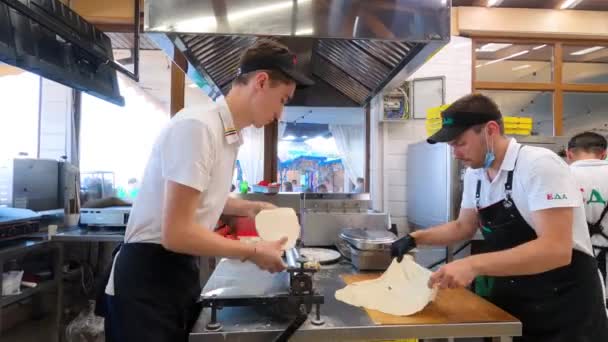 07,21,2021 Russia Moscow male chefs preparing pizza dough in restaurant kitchen — Stockvideo