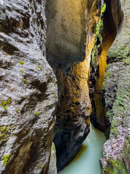 illuminated mystic canyon with turquoise mountain river water of mystic river Aare - gorge Aareschlucht, Meiringen, Switzerland