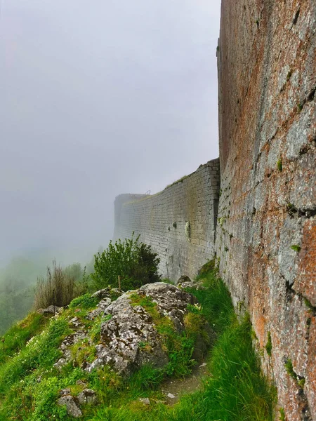 Ruins of the cathar castle of montsegur, in the mist.