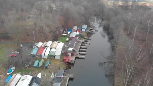 Small Harbor With Shed Buildings, River Canal Scene, Pull Back Rising Aerial — Stock videók