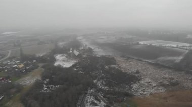 Melting Snow on Field and Forest Misty Day, Pull Back Drone View
