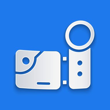 Kağıt kesikli sinema kamera simgesi mavi arkaplanda izole edildi. Video kamera. Film tabelası. Film projektörü. Kağıt sanatı tarzı. Vektör İllüstrasyonu.