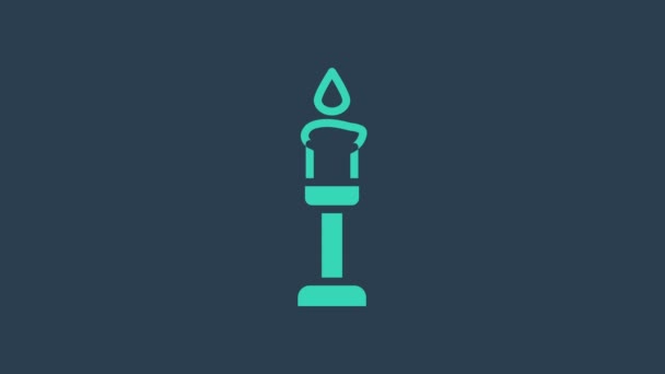 Turquoise Burning candle icon isolated on blue background. Cylindrical aromatic candle stick with burning flame. Happy Halloween party. 4K Video motion graphic animation — Stock Video