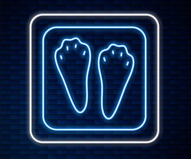 Parlayan neon hattı Tavşan ve Tavşan pençesi ayak izi ikonu tuğla duvar arka planında izole edilmiş. Vektör.