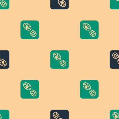 Yeşil ve siyah insan ayak izi ayakkabı ikonu bej arka planda izole edilmiş pürüzsüz desen. Ayakkabı tabanı. Vektör.