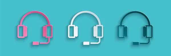 Icono de auriculares de corte de papel aislado sobre fondo azul. Auriculares. Concepto para escuchar música, servicio, comunicación y operador. Estilo de arte de papel. Vector — Vector de stock