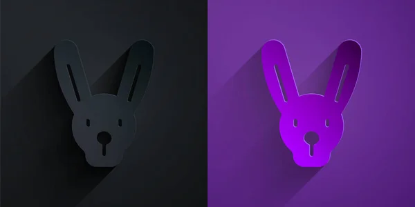 Paper cut Rabbit with ears icon isolated on black on purple background. Magic trick. Mystery entertainment concept. Paper art style. Vector — Image vectorielle