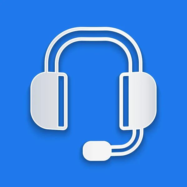 Papel corte Headphones ícone isolado no fundo azul. Suporte de atendimento ao cliente, hotline, call center, faq, manutenção. Estilo de arte de papel. Vetor — Vetor de Stock