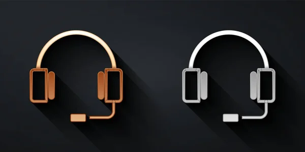 Ouro e prata Headphones ícone isolado no fundo preto. Fones de ouvido. Conceito para ouvir música, serviço, comunicação e operador. Estilo de sombra longo. Vetor — Vetor de Stock