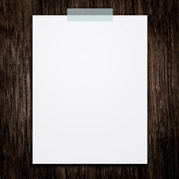 Empty white paper sheet stick on wood texture background. — Stock Photo, Image