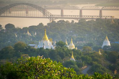 The bridge across Irrawadee river and the old pagodas in Sagaing Area. clipart