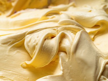 Vanilya aromalı dondurma - tüm çerçeve ayrıntıları. Vanilyalı dondurmanın bej rengi yüzey dokusunu kapat.