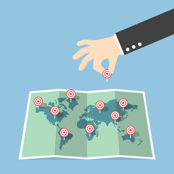 Businessman mano pin objetivo al mapa del mundo — Vector de stock