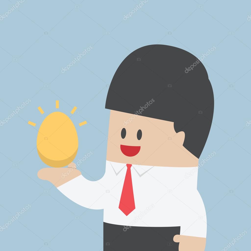 Businessman holding golden egg in his hand