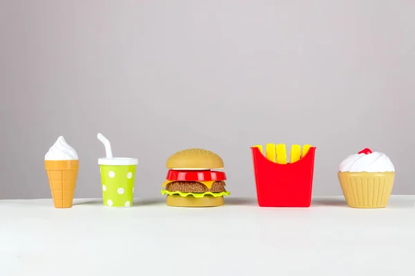 Plastic fast food on white background. Unhealthy. Not organic