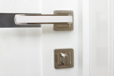 Yakın çekim - modern metal saplı beyaz ahşap bir kapı