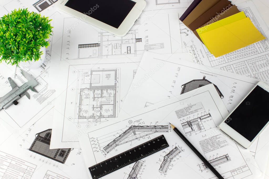 Engineering and architecture drawings on workplace. Architect Desk with Engineering blueprint. Plan drawings.