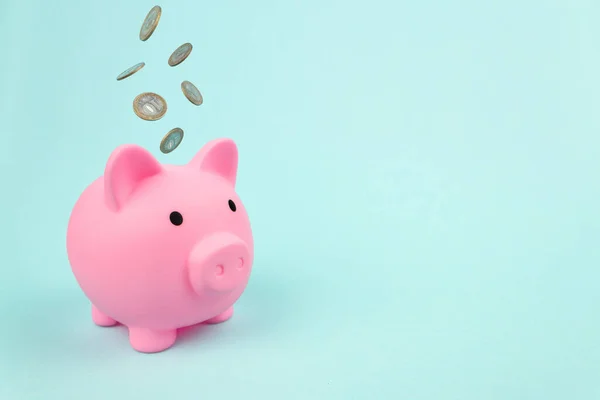 Pink Piggy Bank Falling Coins Blue Background Financial Savings Banking — 스톡 사진