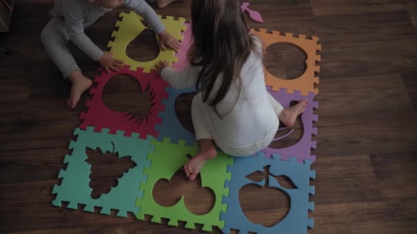 미취학 바닥에 부분의 부드러운 퍼즐을 모은다 아이들과 누나들은 가정에서 기술을 — 비디오