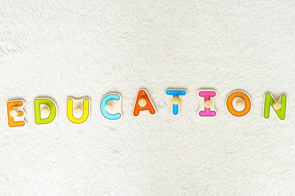 School board. The child draws on the board with chalk. Preparing for school. Education for the youngest. Preschool education in kindergartens. The word education is written in colored wooden letters — Stock Photo, Image