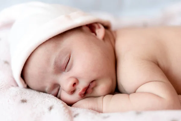 La infancia, el cuidado, la maternidad, la salud, la medicina, los conceptos de pediatría - Primer plano Poca paz calma bebé recién nacido desnudo niña en el sombrero rosa duerme descansando tomar una profunda siesta acostado en la barriga en la cama suave. —  Fotos de Stock