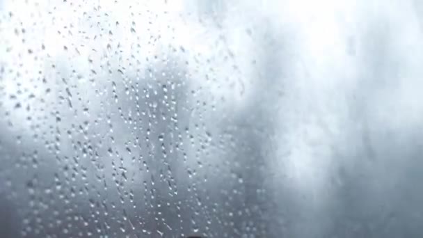 Transport, road, railway, landscape, comnication concept - close up drips of rain flow down window glass of high-speed train. travel through countryside by rail. running streams of water background — Stock Video