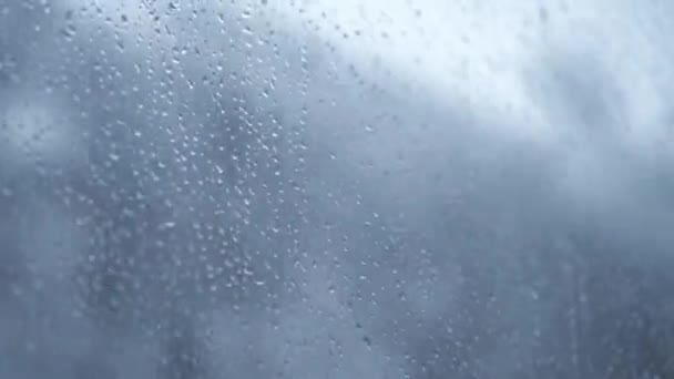 Transport, road, railway, landscape, comnication concept - close up drips of rain flow down window glass of high-speed train. travel through countryside by rail. running streams of water background — Stock Video