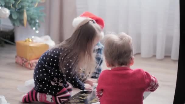 Auténtica alegría feliz niños caja abierta con regalos regocijarse por el juego del árbol de Navidad divertirse juntos. Los niños preescolares celebran el ambiente festivo de Año Nuevo en casa. Invierno, vacaciones, concepto familiar — Vídeos de Stock