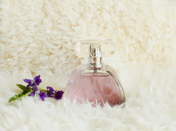 Garrafa com perfume e flores — Fotografia de Stock