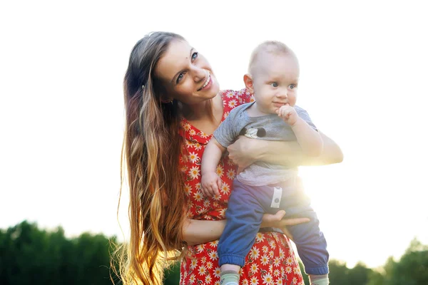 Young and happy mother holds on hands of his young son — Stock Photo, Image