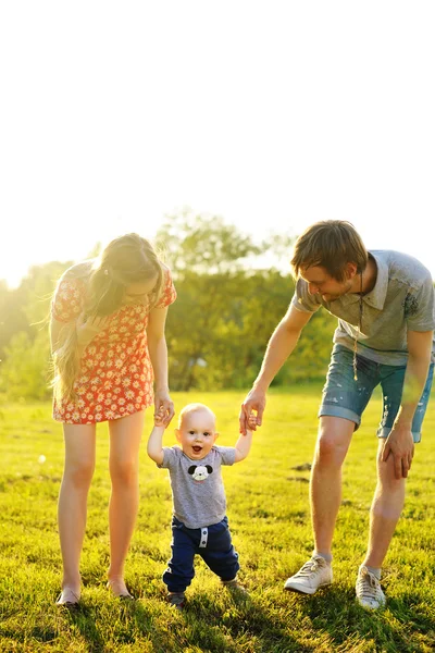 Happy family goes for a walk in park — Stock Photo, Image
