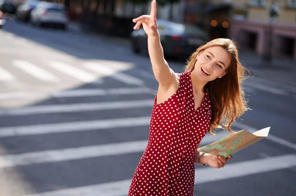 Giovane viaggiatore donna in possesso di mappa cartacea della città e chiamando qualcuno per strada in estate — Foto Stock