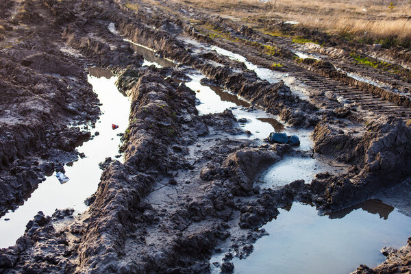 Mud and puddles on the dirt road
