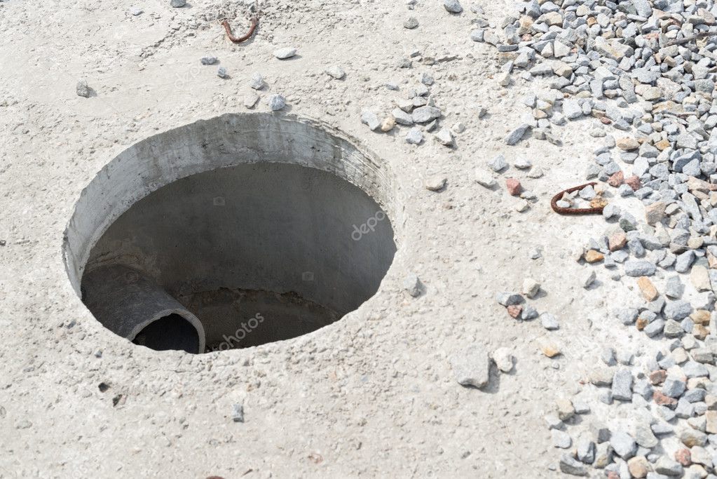 Manhole without cover in new concrete block 