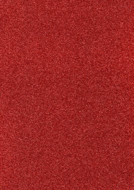 Red glitter texture surface. Shimmering background for backdrop and accent design.
