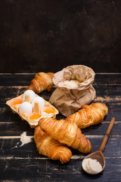 Croissants, flour, eggs, spoon, rolling pin — Stock Photo, Image