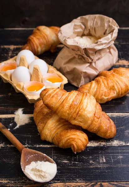 Croissants, flour, eggs, spoon, rolling pin — Stock Photo, Image